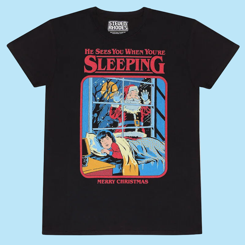 Black t-shirt with a festive graphic of Santa peeking through a window at a child, with text 'He Sees You When You're Sleeping' and 'Merry Christmas'.