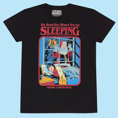 Black t-shirt with a festive graphic of Santa peeking through a window at a child, with text 'He Sees You When You're Sleeping' and 'Merry Christmas'.