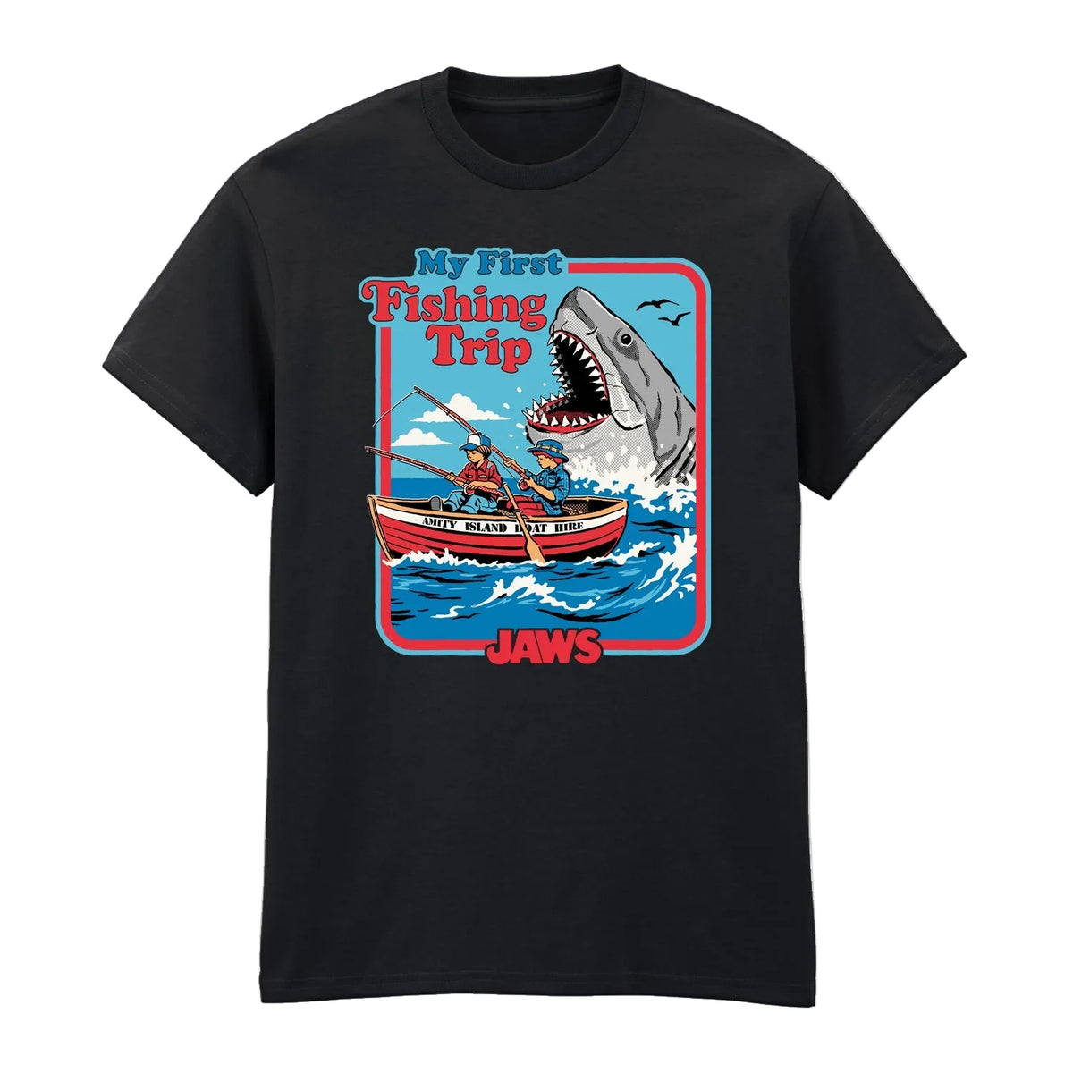 A black short-sleeve crewneck t-shirt featuring a colorful graphic print on the front. The graphic depicts a cartoon shark with an open mouth looming over a red and white fishing boat with two people on the water, with the text 'My First Fishing Trip' and 'JAWS'.