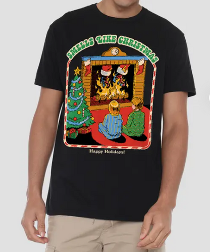 A man wearing a black crewneck t-shirt with a colorful Christmas-themed graphic print that reads 'Smells Like Christmas' and 'Happy Holidays!'.