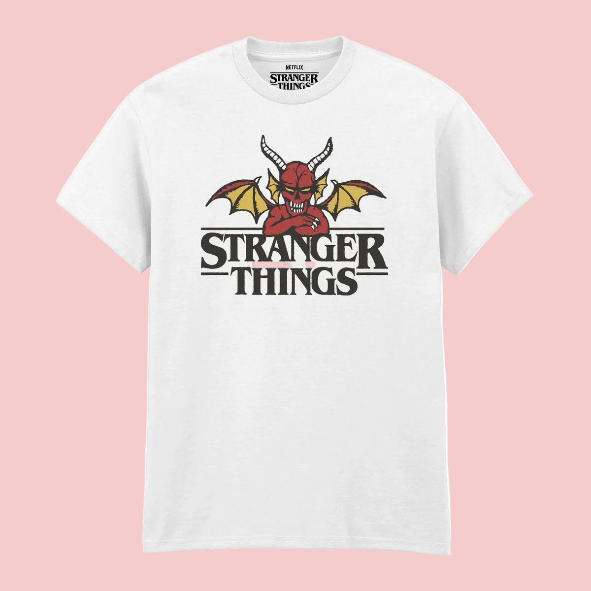 A white short-sleeve crewneck t-shirt featuring a graphic of a red devil with yellow wings above the text 'STRANGER THINGS'. The neck label also displays the 'Stranger Things' logo.