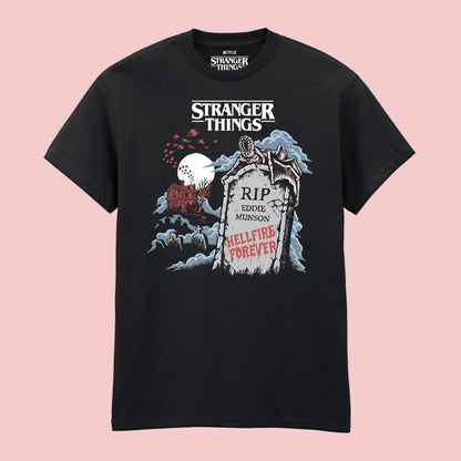 A black short-sleeve t-shirt featuring a graphic print from Stranger Things. The graphic includes the white 'Stranger Things' logo at the top, a tombstone reading 'RIP Eddie Munson' and 'Hellfire Forever' in red, a red house, and a red sky with a white moon.