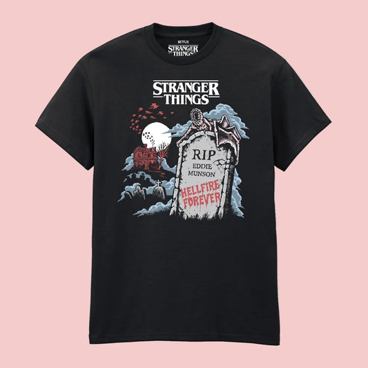 A black short-sleeve t-shirt featuring a graphic print from Stranger Things. The graphic includes the white 'Stranger Things' logo at the top, a tombstone reading 'RIP Eddie Munson' and 'Hellfire Forever' in red, a red house, and a red sky with a white moon.