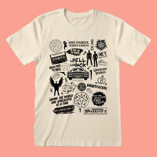 An off-white short-sleeve t-shirt with a black graphic collage of various horror-themed logos, quotes, and illustrations, displayed against a solid coral pink background.
