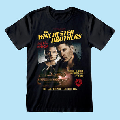 A black short-sleeve crewneck t-shirt featuring a graphic print of 'The Winchester Brothers: Hell on Earth' from Supernatural. The graphic includes the show's title in yellow, a portrait of Dean Winchester, Sam Winchester, a car, and red and yellow text.