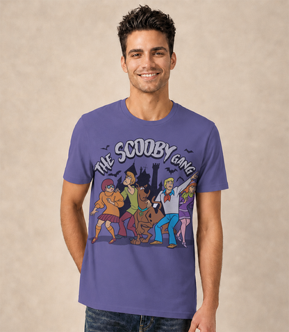 Man wearing a dusk blue t-shirt with 'The Scooby Gang' graphic design on the front against a beige background