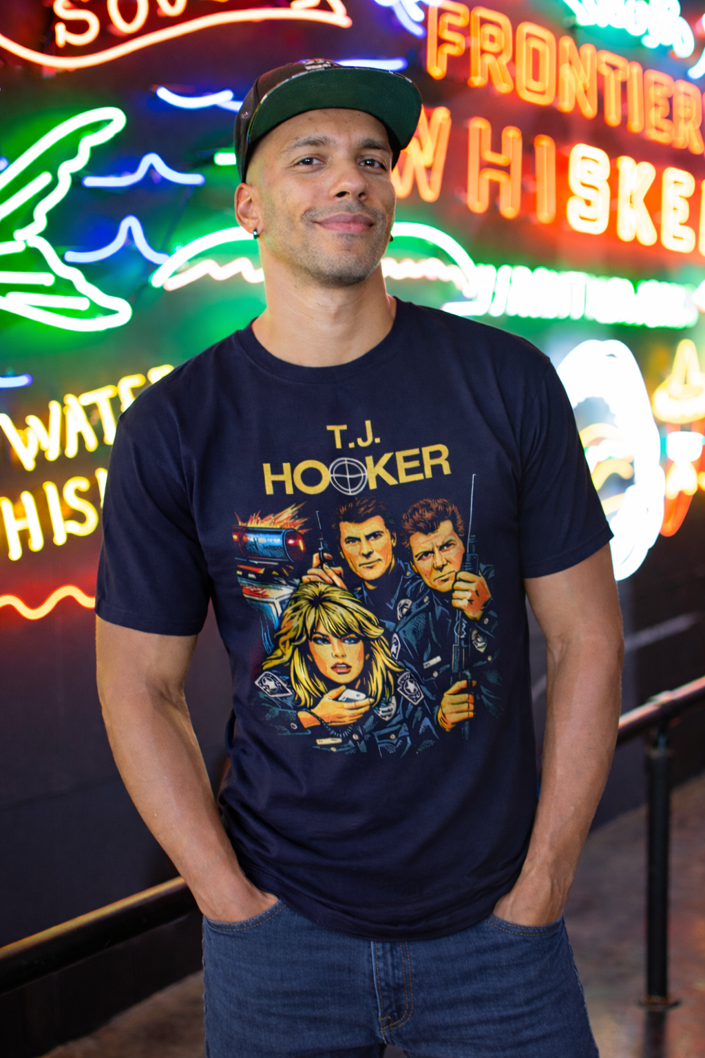 Man wearing a T.J. Hooker t-shirt in front of neon signs