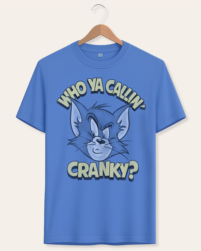 Official Tom and Jerry Blue t-shirt with cartoon Tom character and Who Ya Callin' Cranky? text on a hanger against a white background