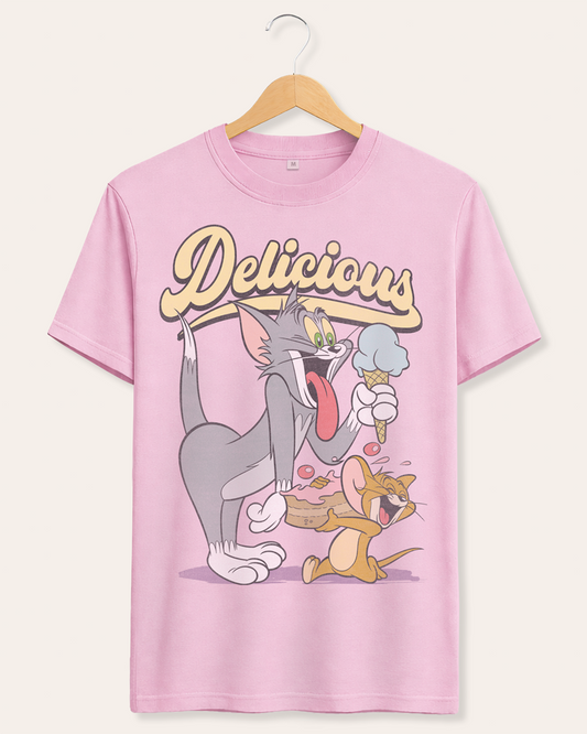 Official Tom and Jerry Pink t-shirt with cartoon Tom eating ice cream and Jerry eating cake and 'Delicious' text above on a hanger against a white background