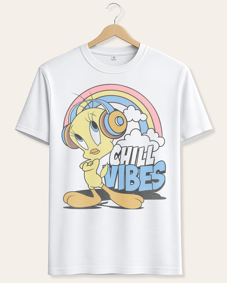 A white short-sleeve crewneck t-shirt hanging on a wooden hanger against a light beige background. The shirt features a colorful graphic of Tweety Pie wearing headphones under a pastel rainbow with the text 'CHILL VIBES'. Official Looney Tunes