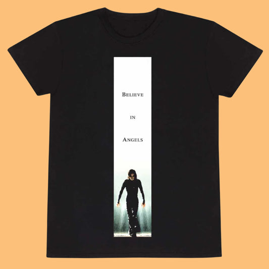 A black t-shirt with a white and gray poster of 'The Crow' character in the center, and the text 'BELIEVE IN ANGELS' above it.