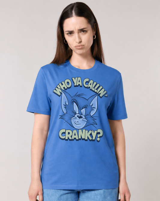 A woman modeling a blue graphic t-shirt featuring Tom and Jerry's cartoon character with the text 'WHO YA CALLIN' CRANKY?'.