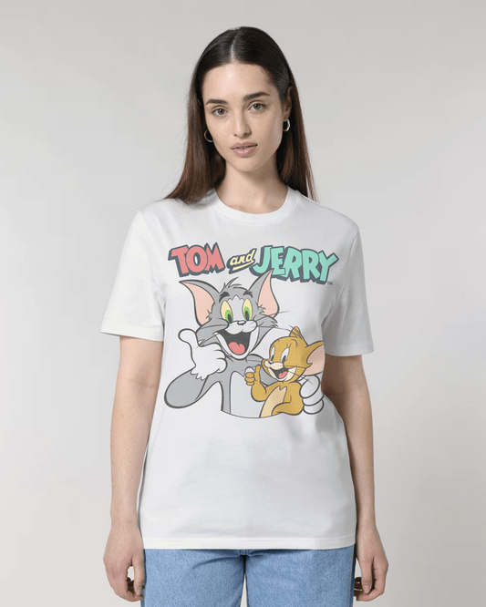 A woman modeling a white graphic t-shirt featuring the 'Tom and Jerry' cartoon characters on the front, set against a plain light gray studio background.