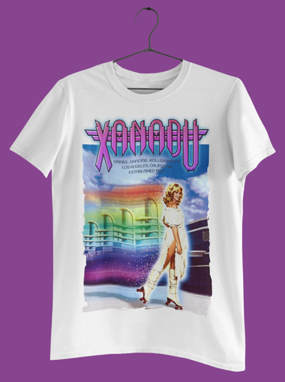 White t-shirt with 'Xanadu' movie poster design featuring a woman in a white dress and colorful background.