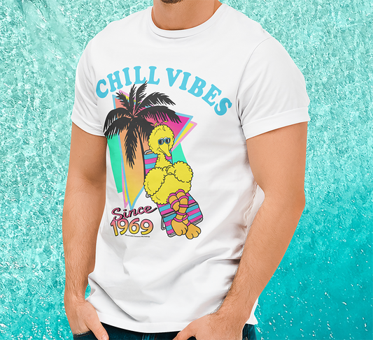 Man wearing Official Sesame Street T-shirt by Famous Forever.  Unisex short sleeve crew neck white t-shirt featuring retro 80s style Big Bird with shades on on a sun lounger design with Chill Vibes text above and since 1969 below. 
