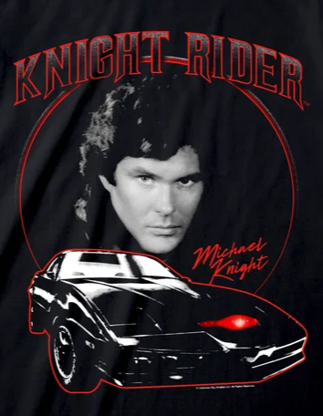 A black short-sleeve graphic t-shirt featuring a 'Knight Rider' design with Michael Knight's portrait, the car, and red text on a white background.