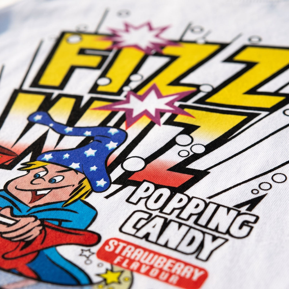 Close-up of colourful Fizz Wiz Popping Candy retro graphic on white T-shirt