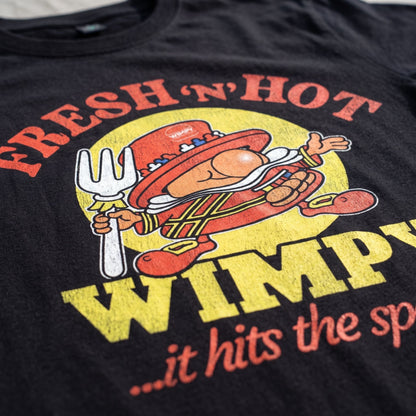 Close-up of Fresh n Hot Wimpy retro graphic printed on black T-shirt