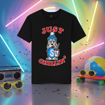 A black short-sleeve crewneck t-shirt featuring a cartoon dog graphic in a blue beanie holding a drink, with the red text 'JUST CHILLIN'' printed above and below.