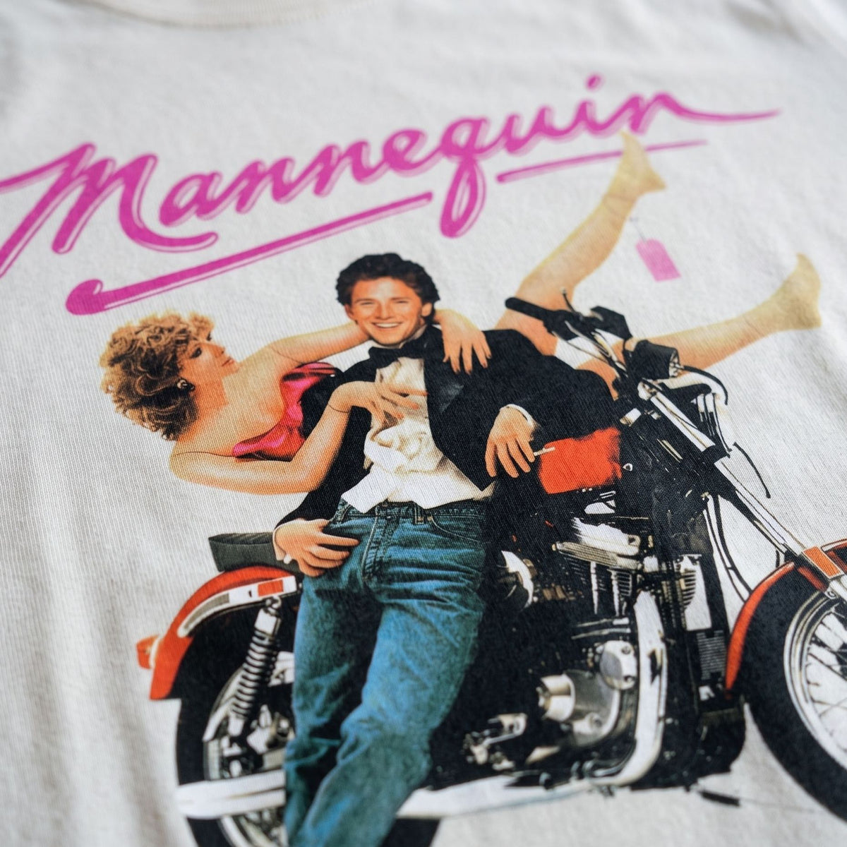 Close-up of colourful Mannequin 80s movie inspired graphic on white T-shirt