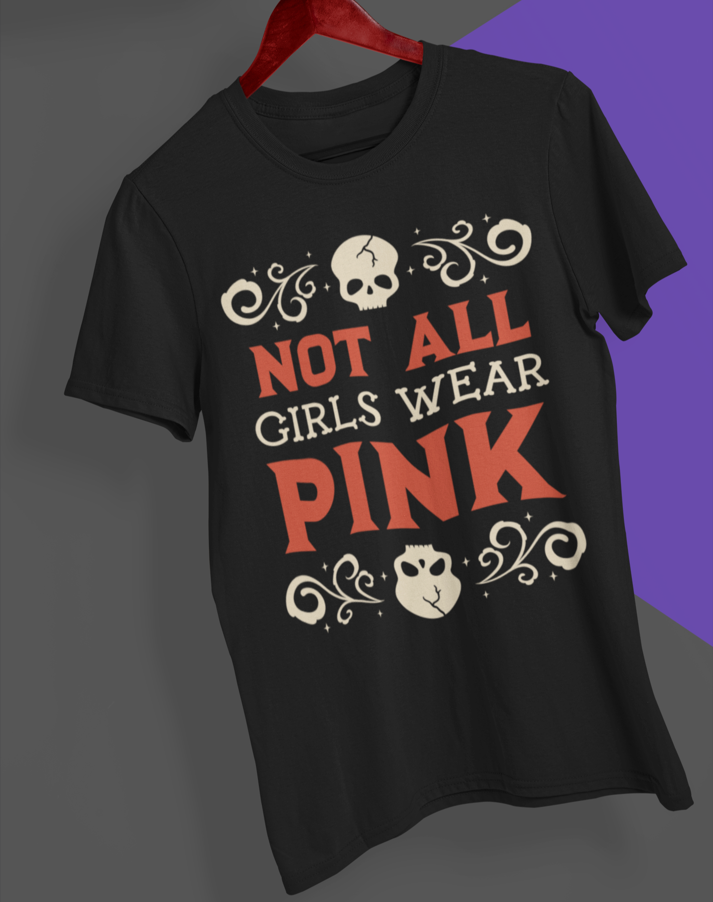 Black t-shirt with 'Not All Girls Wear Pink' text on a hanger against a gray and purple gradient background.