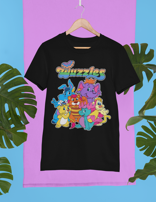 Black t-shirt with colorful cartoon characters and 'Wuzzles' text on a pink and blue background with leaves.